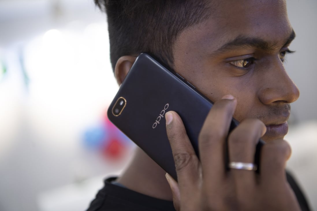 A man uses an Oppo smartphone at a shopping centre in Chennai, India, in October of last year. Photo: Xinhua