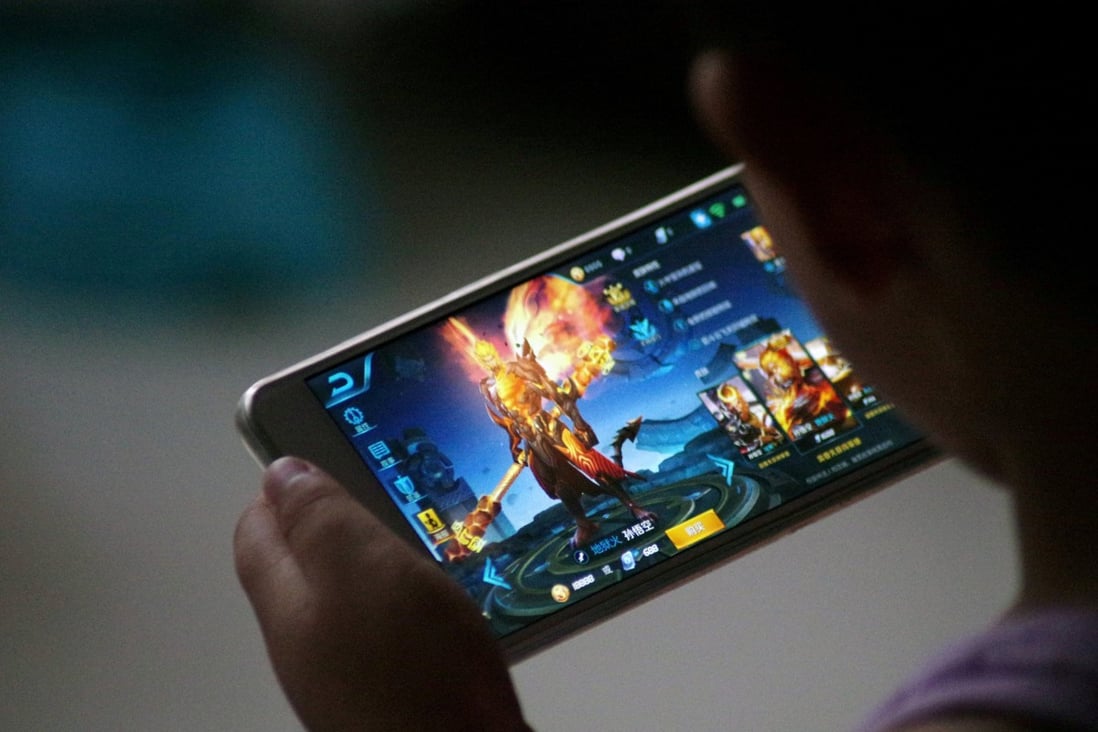 A child plays Tencent’s game Honour of Kings which led the charts with daily active users surpassing 100 million over the Lunar New Year holiday. Photo: Reuters