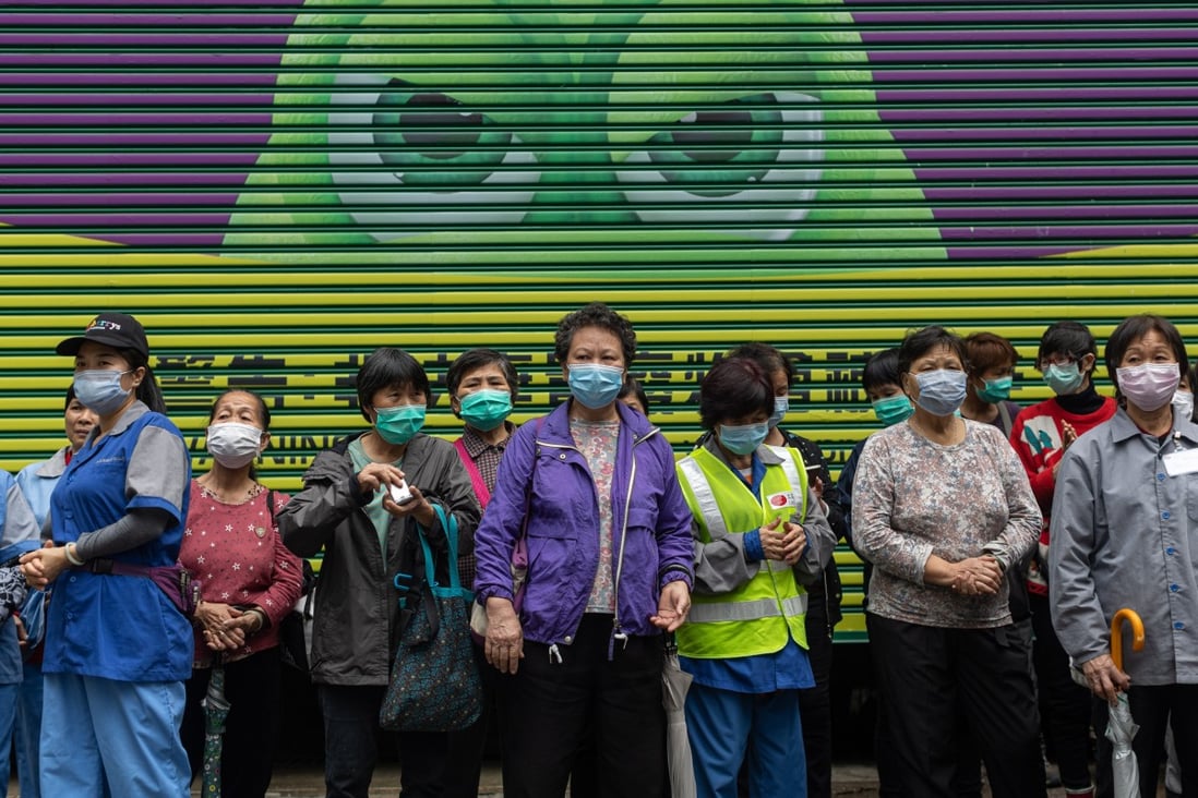 Street cleaners in Hong Kong wait in line to receive free face masks amid the coronavirus outbreak. Photo: EPA-EFE