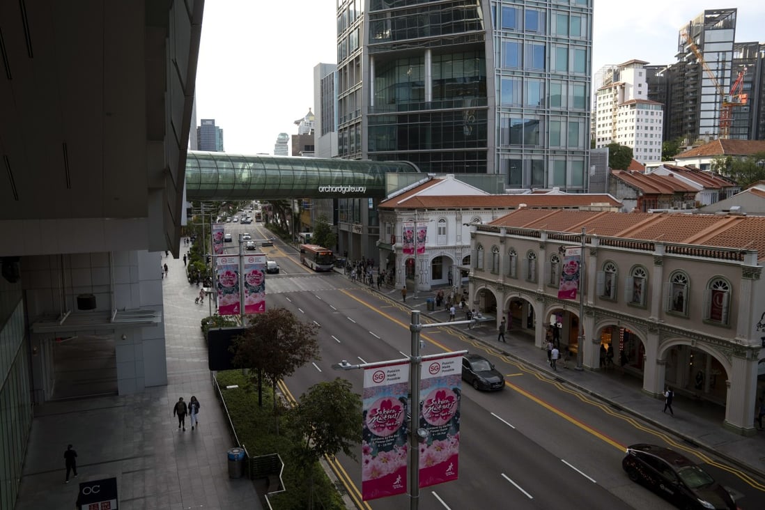 Pedestrians walk along a near-empty Orchard Road in Singapore on March 24. Photo: Bloomberg