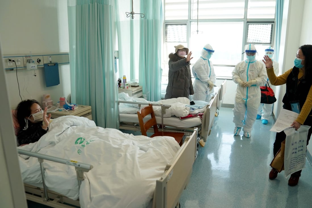 A woman who recovered from Covid-19 says farewell as she leaves hospital in Wuhan. Photo: Xinhua