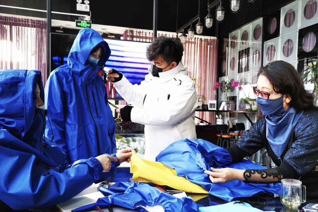 Beijing-based designer Liu Wei works on her windbreaker design during the coronavirus epidemic in China. She says protective clothing designed for specialists such as firefighters, disease prevention teams, and soldiers had found new appeal with members of the Chinese public.