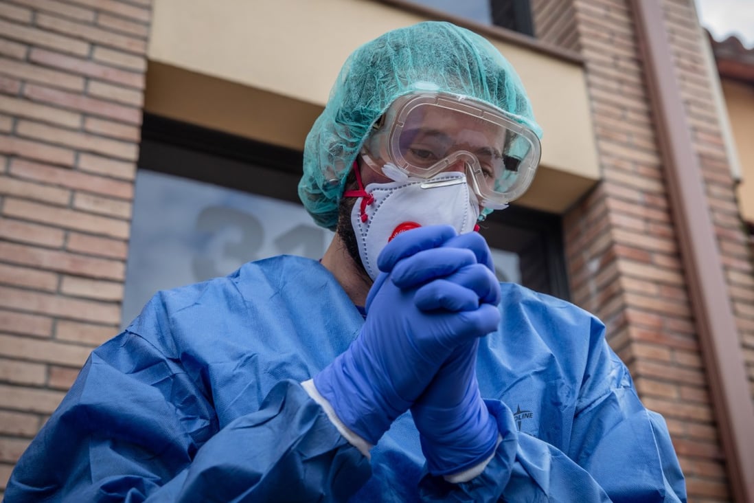 A researcher prepares to enter the home of a Covid-19 patient in Sant Antoni de Vilamajor, Spain. The disease has killed over 4,000 people in the country. Photo: Bloomberg