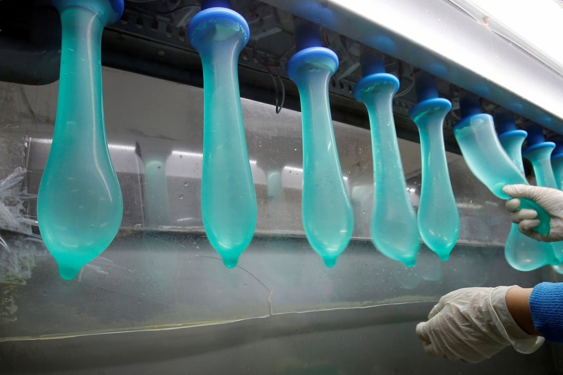 A worker performs a test on condoms at Karex’s factory in Pontian, Malaysia. Photo: Reuters