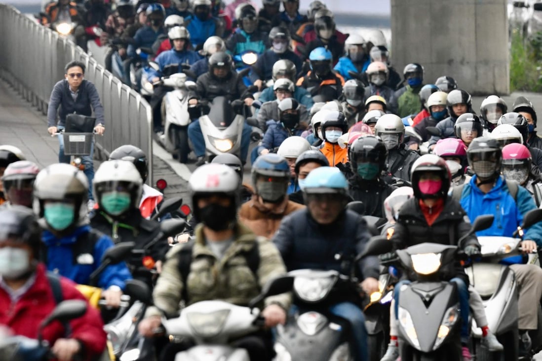 Motorcyclists wear face masks during the morning commute in Taipei. Photo: AFP