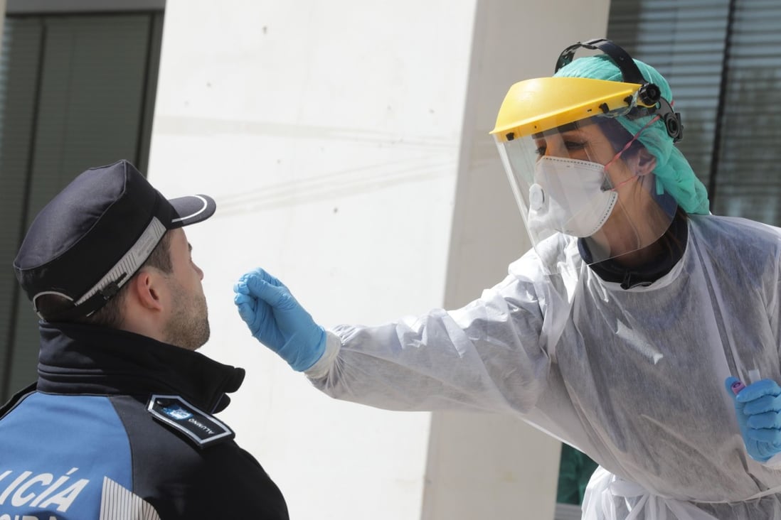 A police officer is given a swab test at Madrid city hall. Photo: AFP