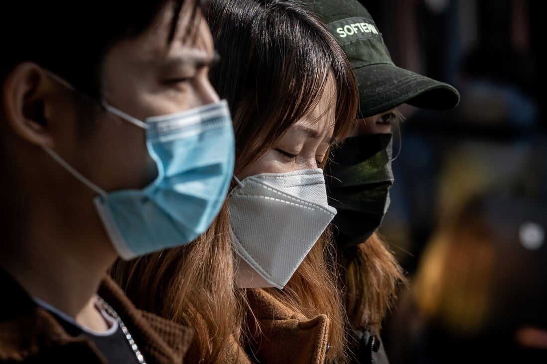 In this picture taken on March 11, 2020 people wearing face masks as a preventive measure against the COVID-19 coronavirus walk outside of a shopping mall in Beijing. Photo: AFP