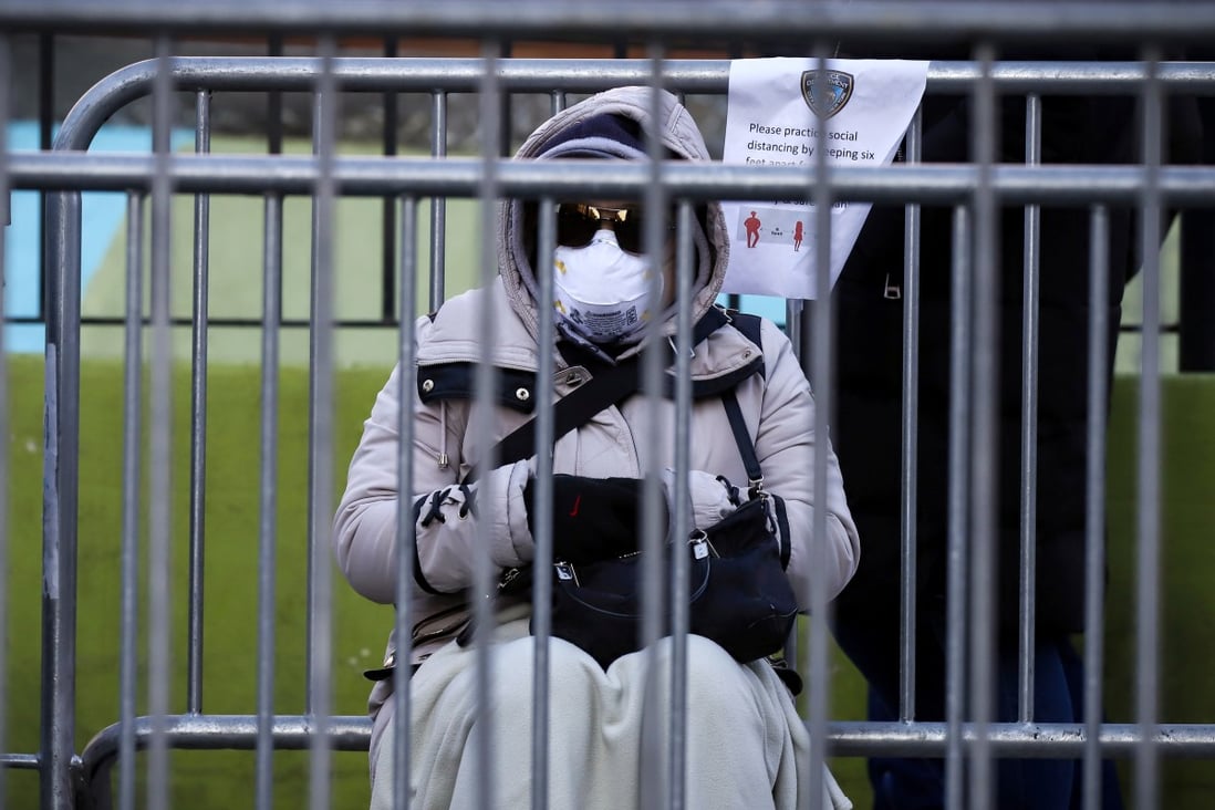 A person waits in line to be tested for the coronavirus disease while wearing protective gear, outside Elmhurst Hospital Center in the Queens borough of New York City on March 26, 2020. Photo: Reuters
