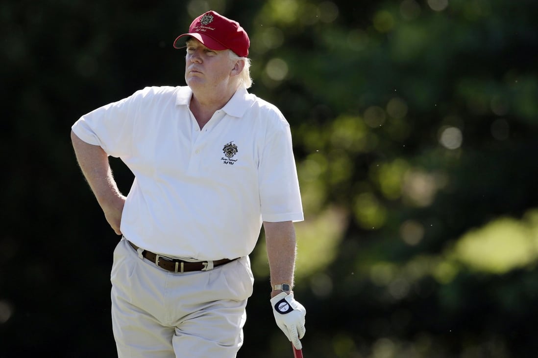 Donald Trump stands on the 14th fairway during a pro-am round of the AT&T National golf tournament at Congressional Country Club in Bethesda, in the US state of Maryland. Trump’s golf game has been put in the spotlight in new book Commander in Cheat. Photo: AP
