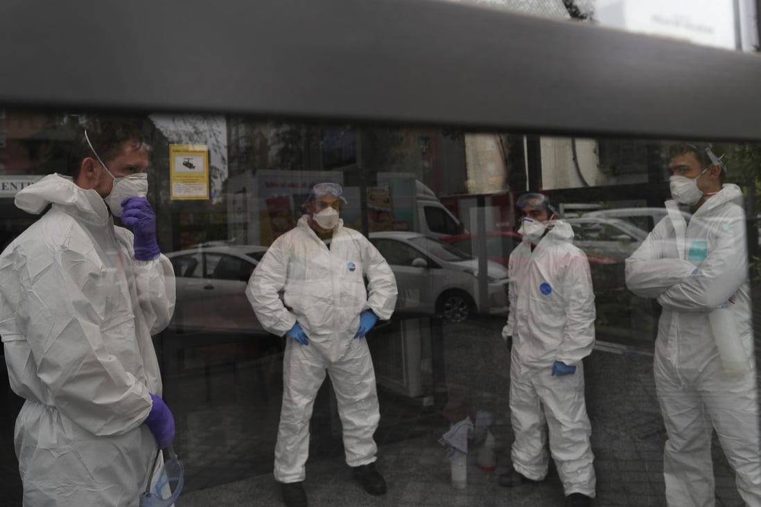Members of the country’s military emergency unit prepare to disinfect at a nursing home in Madrid, Spain on Tuesday. Photo: AP