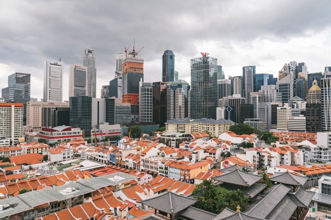 Skyscrapers stand beyond traditional shophouses in the central business district in Singapore. Photo: Bloomberg