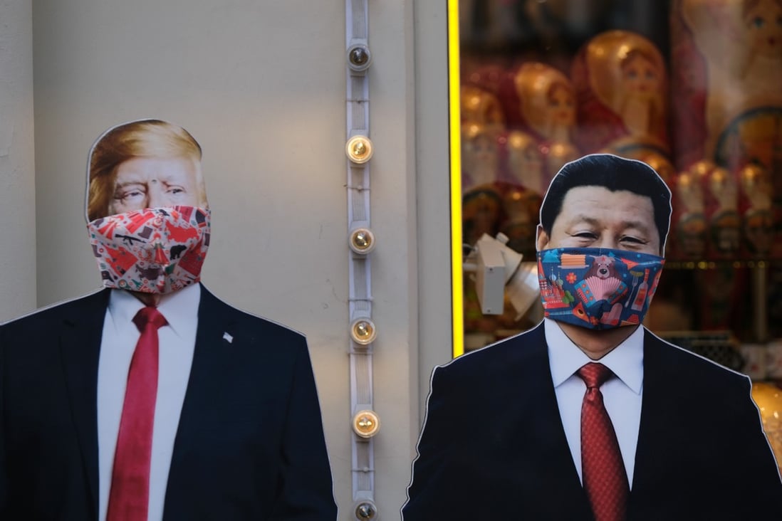 Mask-wearing cut-outs of US President Donald Trump and Chinese President Xi Jinping stand near a gift shop in Moscow, Russia. Photo: Reuters