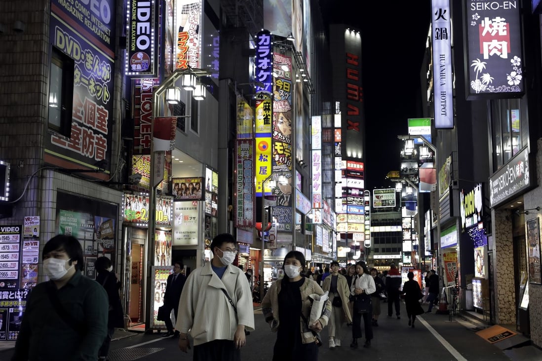 Pedestrians wearing protective face masks walk along a street in the Shinjuku district of Tokyo, Japan. Officials say an increase in Covid-19 cases is linked to nightlife in areas such as Shinjuku. Photo: Bloomberg