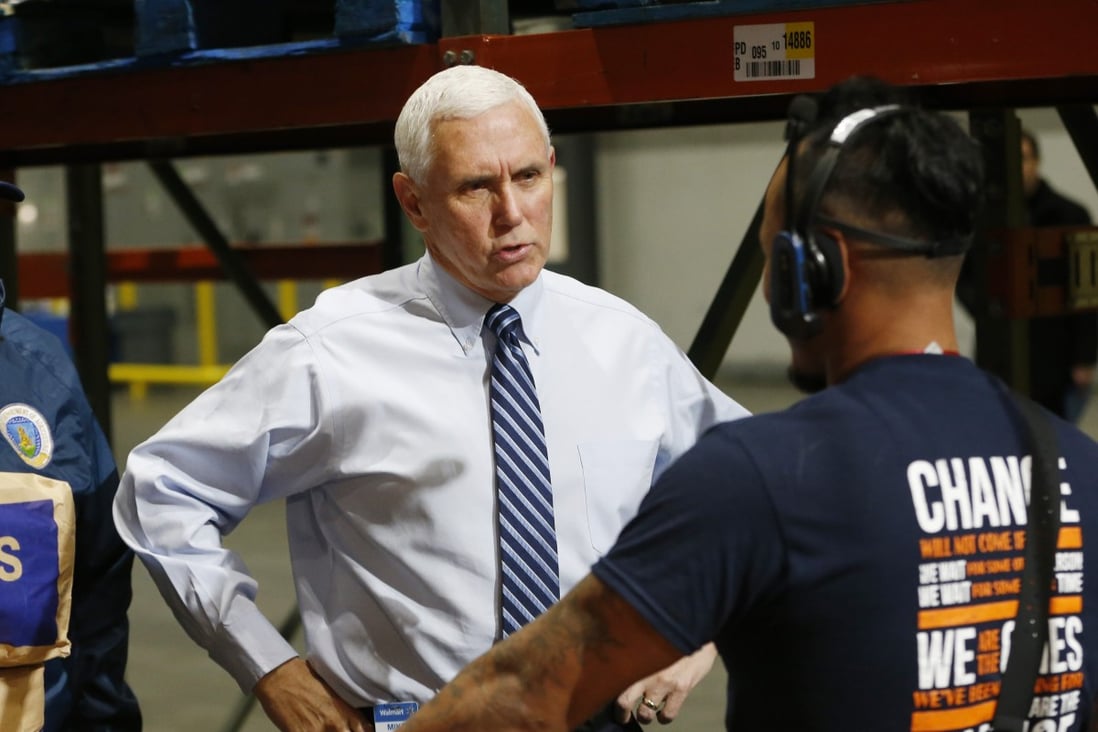 US Vice-President Mike Pence speaks with a worker at a Walmart distribution centre in Gordonsville, Virginia, on Wednesday. Photo: AP