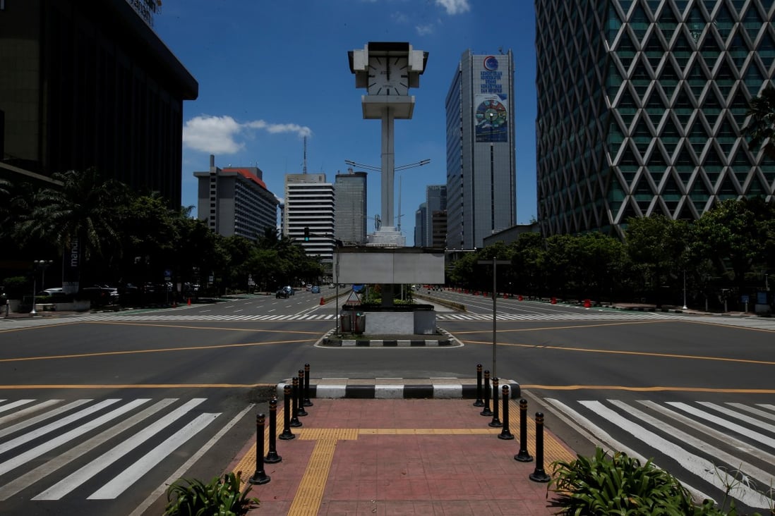 An almost empty intersection at noon on Jalan M.H. Thamrin, one of the main roads in Jakarta. Photo: Reuters