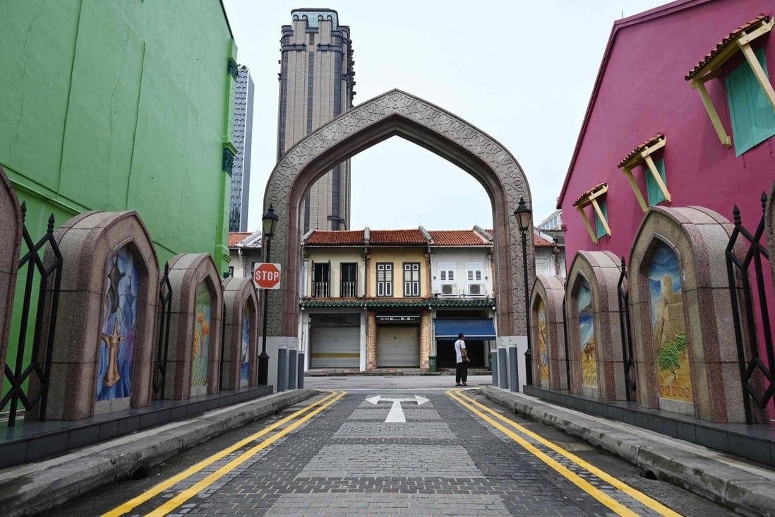 A man stands along a quiet street in Singapore on April 7 as the country ordered the closure of all businesses deemed non-essential as well as schools to combat the spread of Covid-19. Photo: AFP