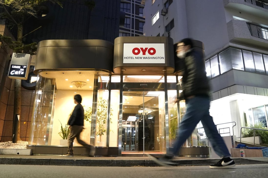 Pedestrians walk past an Oyo hotel in Tokyo. The start-up is placing thousands of employees on indefinite leave in a bid to survive the coronavirus pandemic. Photo: Bloomberg