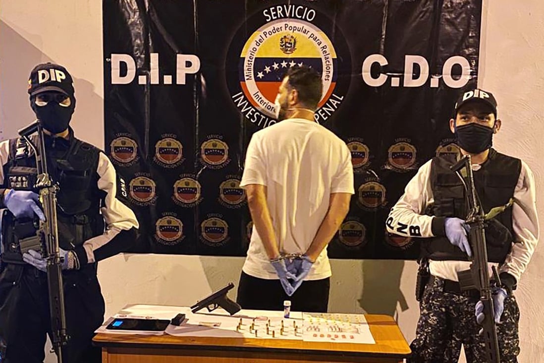 In this March 31, 2020, photo, Venezuelan police officers present a suspect arrested at a multiday party in Caracas, Venezuela, that violated Nicolas Maduro’s order on large gatherings. Photo: AP