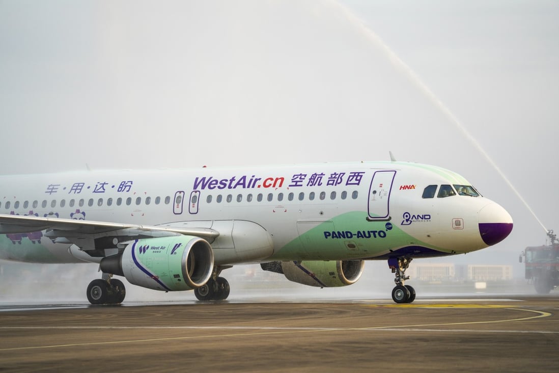 An airplane carrying medics supporting the coronavirus-hit Hubei province receives a water cannon salute as it lands at Chongqing Jiangbei International Airport on March 18, 2020. Photo: Xinhua