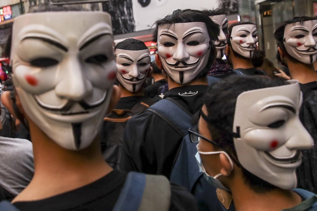 Protesters wearing Guy Fawkes masks take part in an October demonstration against the then newly imposed law banning face masks in public in Hong Kong. Photo: EPA-EFE