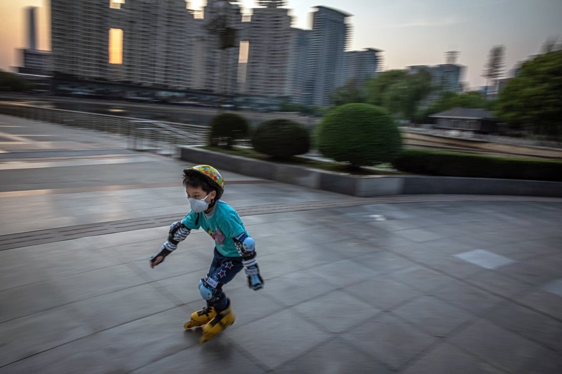 A boy celebrates the lockdown being lifted in Wuhan, China on April 8, 2020. In Wuhan, the epicentre of the coronavirus outbreak, more than 2,500 people died of the coronavirus, according to the government. Photo: EPA-EFE