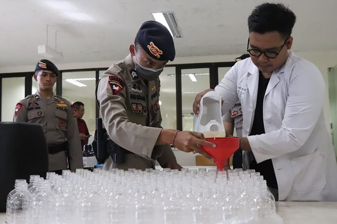 In Bali, police and Udayana University staff have made hand sanitiser from donated arak — fermented palm wine. Photo: Bali Police/AFP