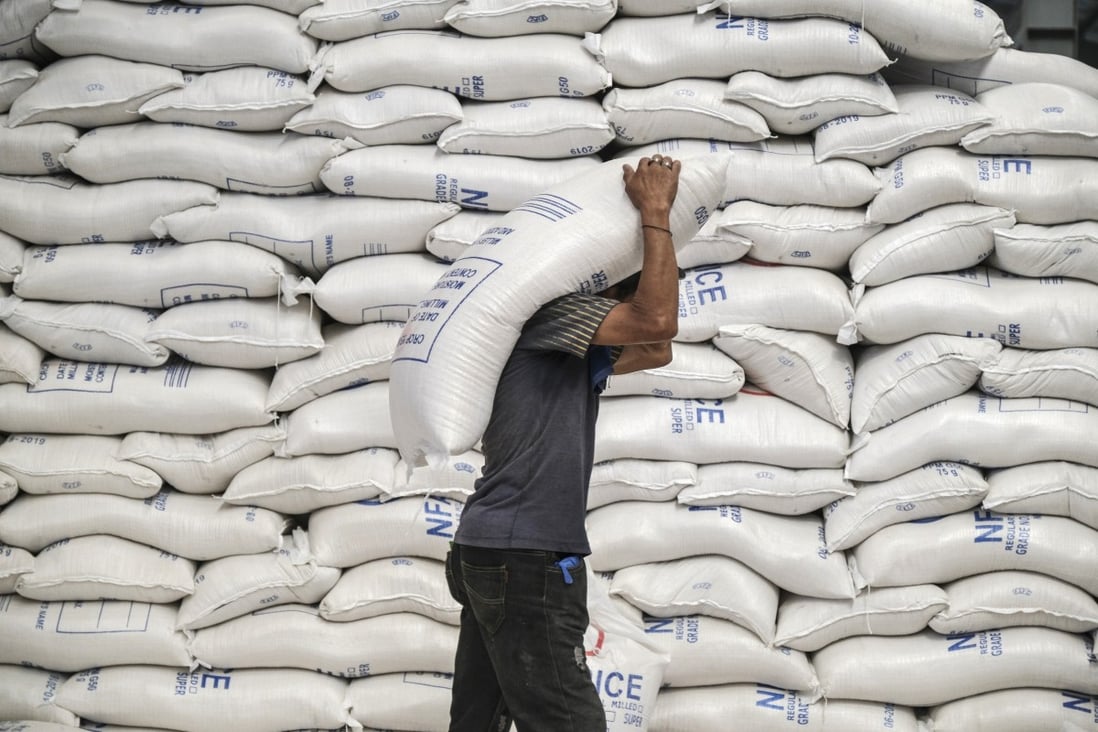 A worker carries a sack of rice inside a National Food Authority warehouse in Valenzuela, Metro Manila, the Philippines, on Thursday, March 26, 2020. File photo: Veejay Villafranca/Bloomberg