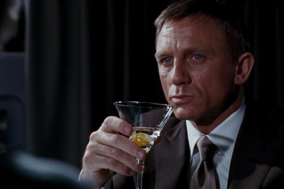 Daniel Craig as James Bond sipping a Vesper, in Casino Royale (2006), a gin-based cocktail with a dash of Russian vodka, two dashes of Lillet Blanc and garnished with an orange twist. Shaken, not stirred, of course. Photo: Handout