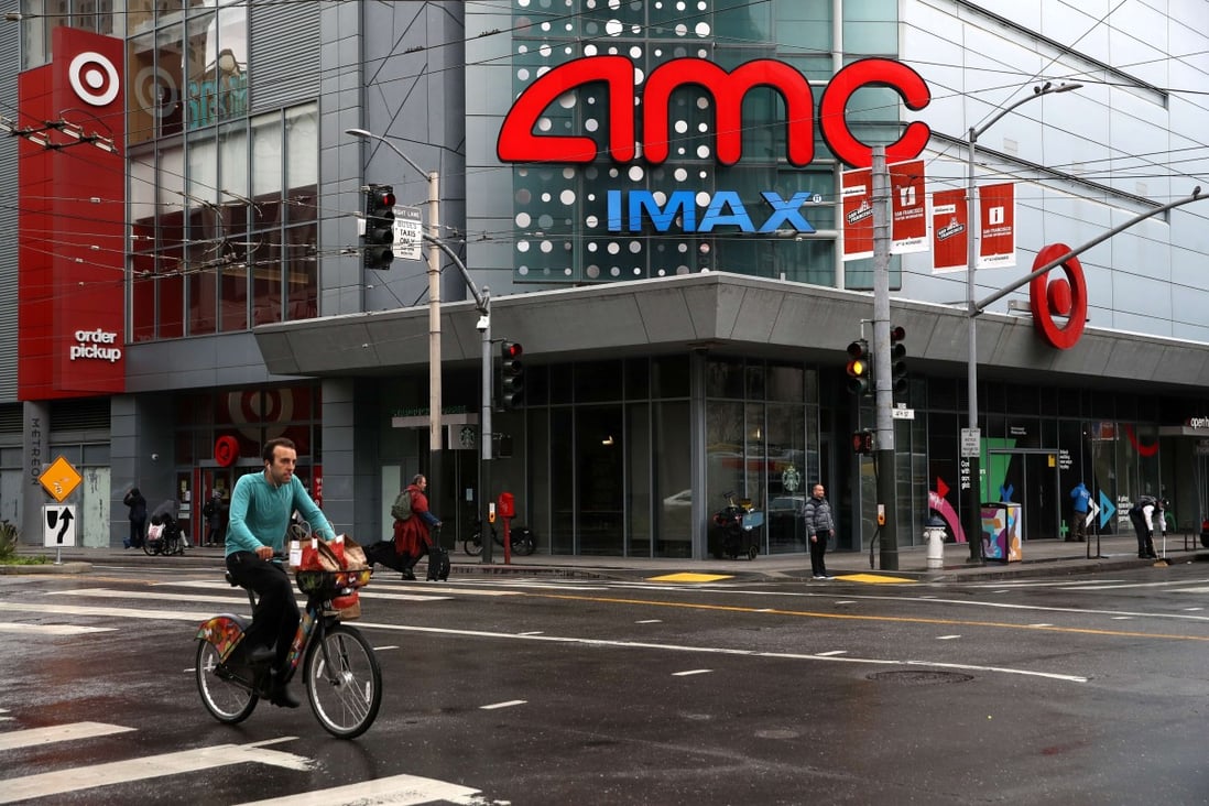 A cyclist rides his bike by an AMC theatre during the coronavirus pandemic in San Francisco. The future of AMC cinemas remains in question after shuttering all of its theatres and furloughing all its staff. Photo: Getty Images