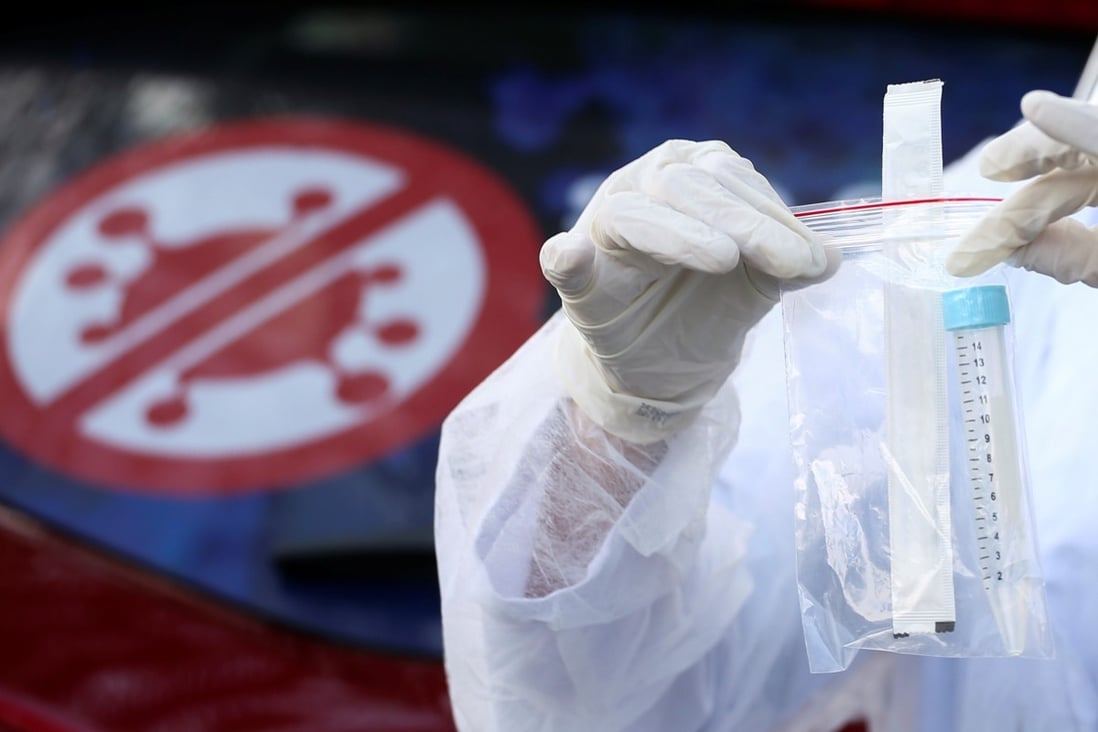 A medical student collects a coronavirus self-test kit in Sao Caetano do Sul, Brazil on Tuesday. Photo: Reuters