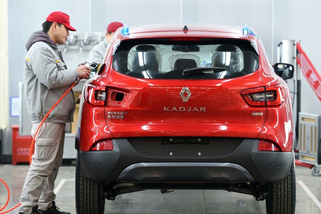 A worker putting the final shine on a Kadjar SUV at a Dongfeng Renault manufacturing plant in Wuhan in central China's Hubei province. Photo: Chinatopix via AP