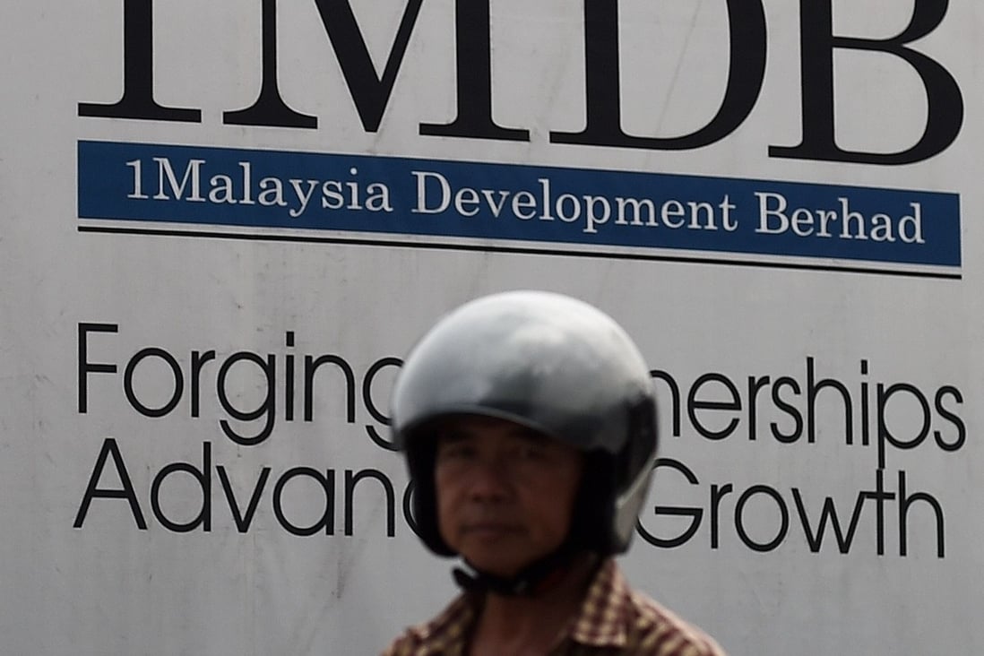 A motorist rides past a hoarding at a construction site funded by 1MDB in Kuala Lumpur in this 2015 file photo. Photo: AFP