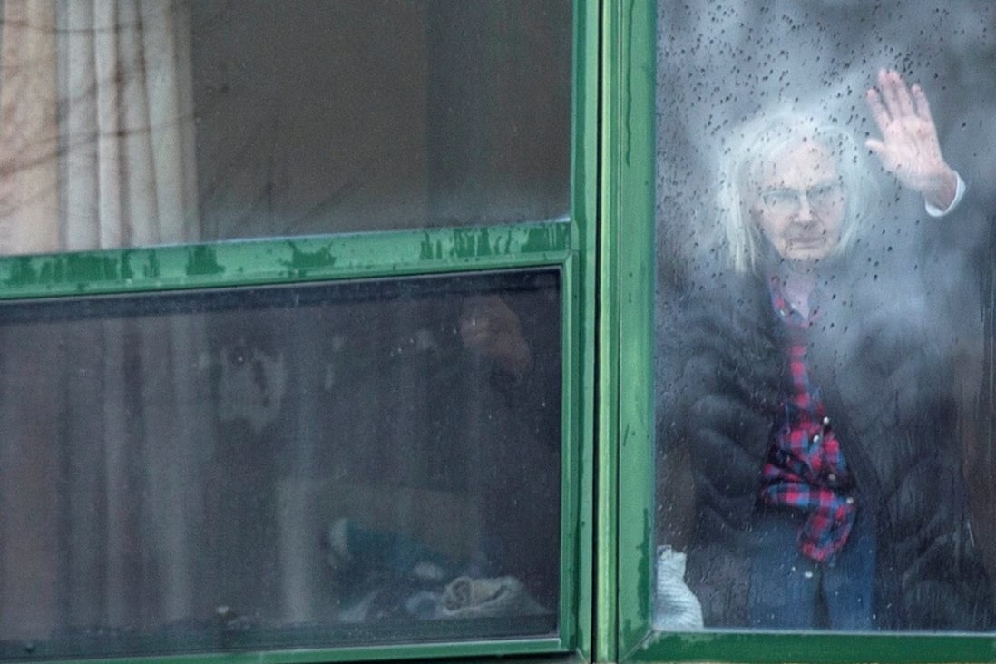 A resident waves from her window at Residence Herron, a long-term care facility in Montreal, where more than 30 residents have died of Covid-19. Photo: Reuters