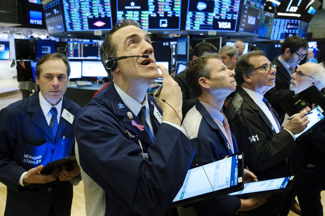 Traders work on the floor of the New York Stock Exchange on March 4. US and global equities are currently down by less than 20 per cent from their all-time highs. Photo: EPA-EFE