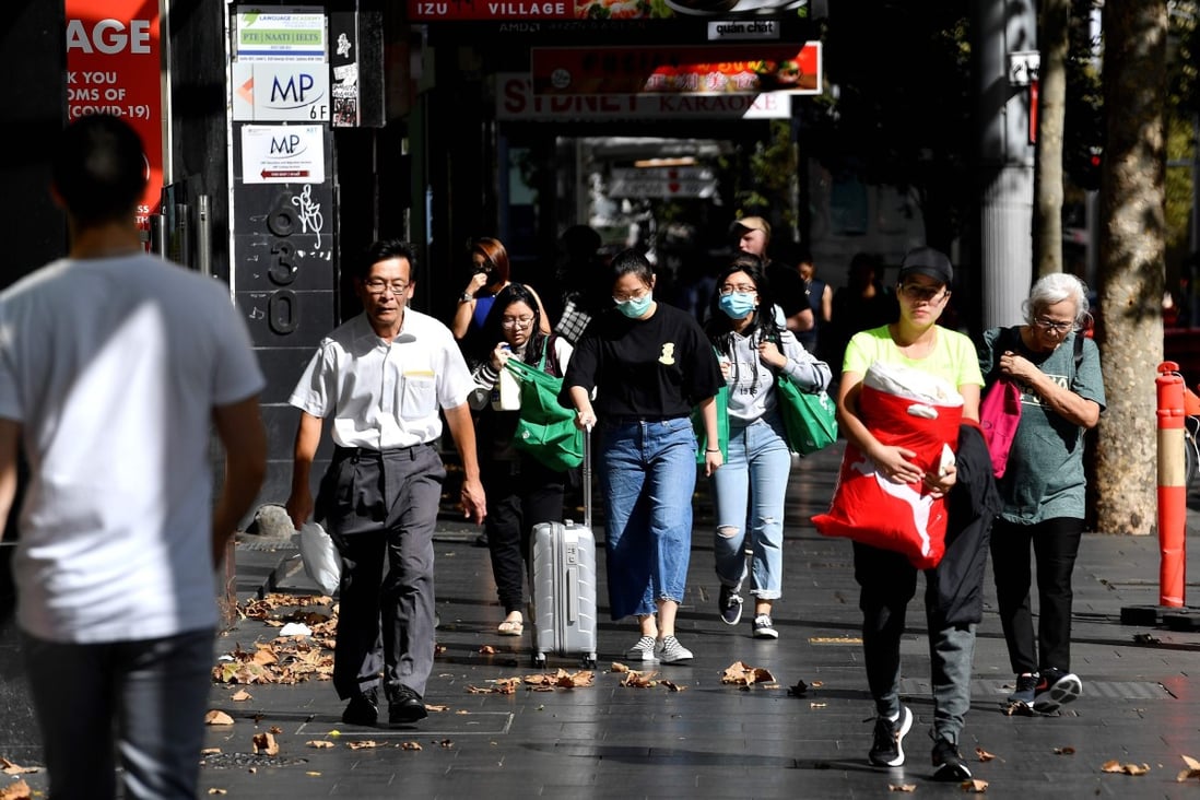 People walk in the streets of Sydney's central business district in Australia on April 11. 2020. Social distancing and other restrictions imposed by authorities are expected to lead to soaring unemployment. Photo: Agence France-Presse