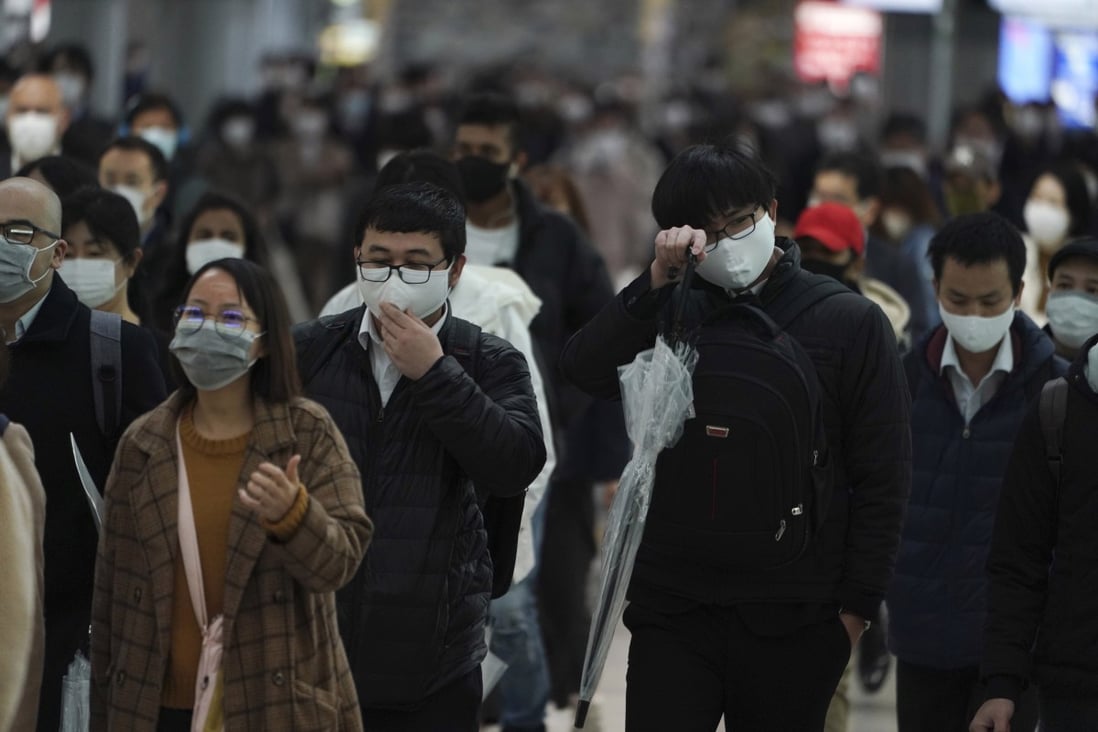 Commuters wearing face marks pictured during rush hour on Monday in a crowded railway station in Tokyo. Photo: AP