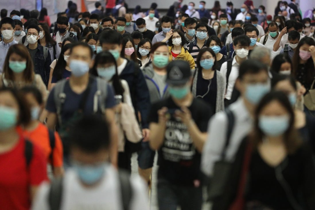 Commuters in face masks is seen going to work at the Hong Kong Station amid the COVID-19 pandemic in the morning, Central. 21APR20 SCMP / Winson Wong