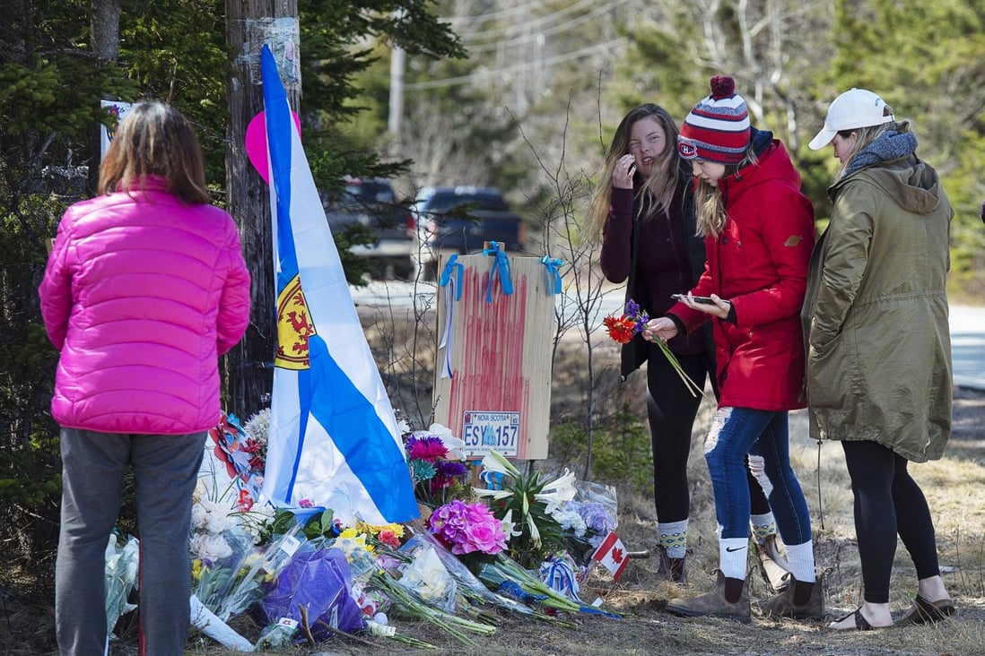 People pay their respects at a memorial in Portapique, Nova Scotia, following last Saturday’s shooting rampage. Photo: AP