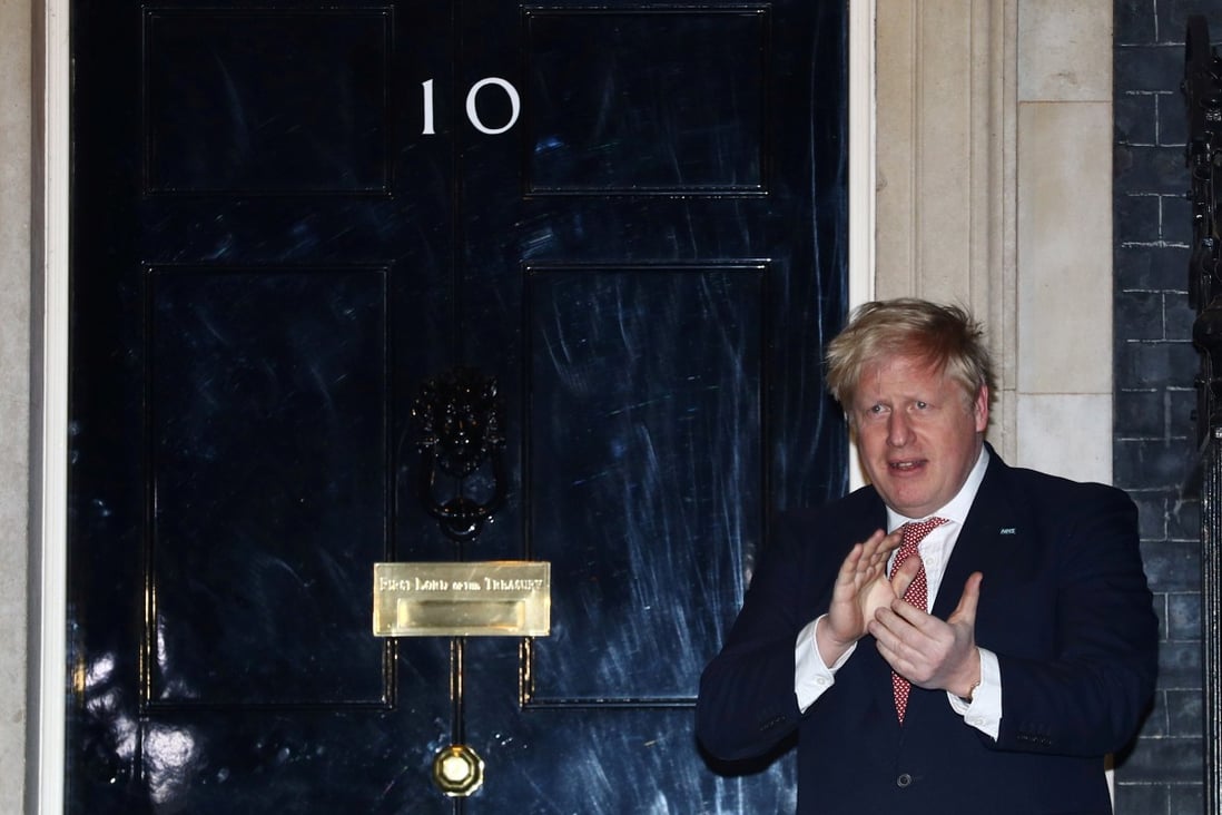 Britain's Prime Minister Boris Johnson applauds outside 10 Downing Street during on March 26. File photo: Reuters