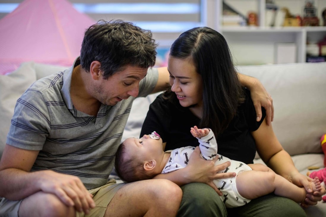 Catherine Kosasih (right) with husband Juergen Ditz and youngest daughter Avielle at their home in Hong Kong after Kosasih recovered from Covid-19. Photo: AFP