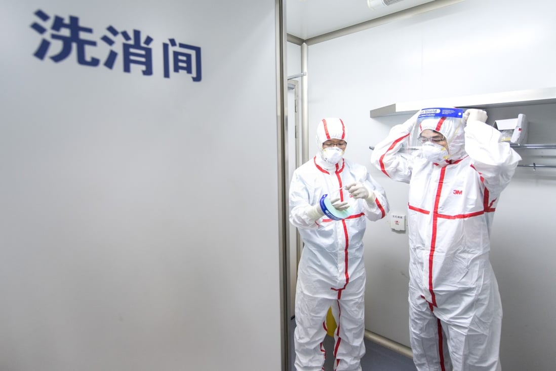 Researchers put on protective suits at the Wuhan Institute of Virology. Photo: Xinhua