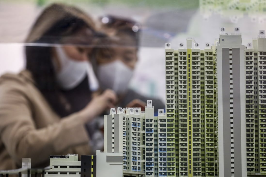 Potential homebuyers wearing protective face masks look at a scale model of a Hong Kong housing project in March as the government begins to ease coronavirus restrictions. Photo: Winson Wong