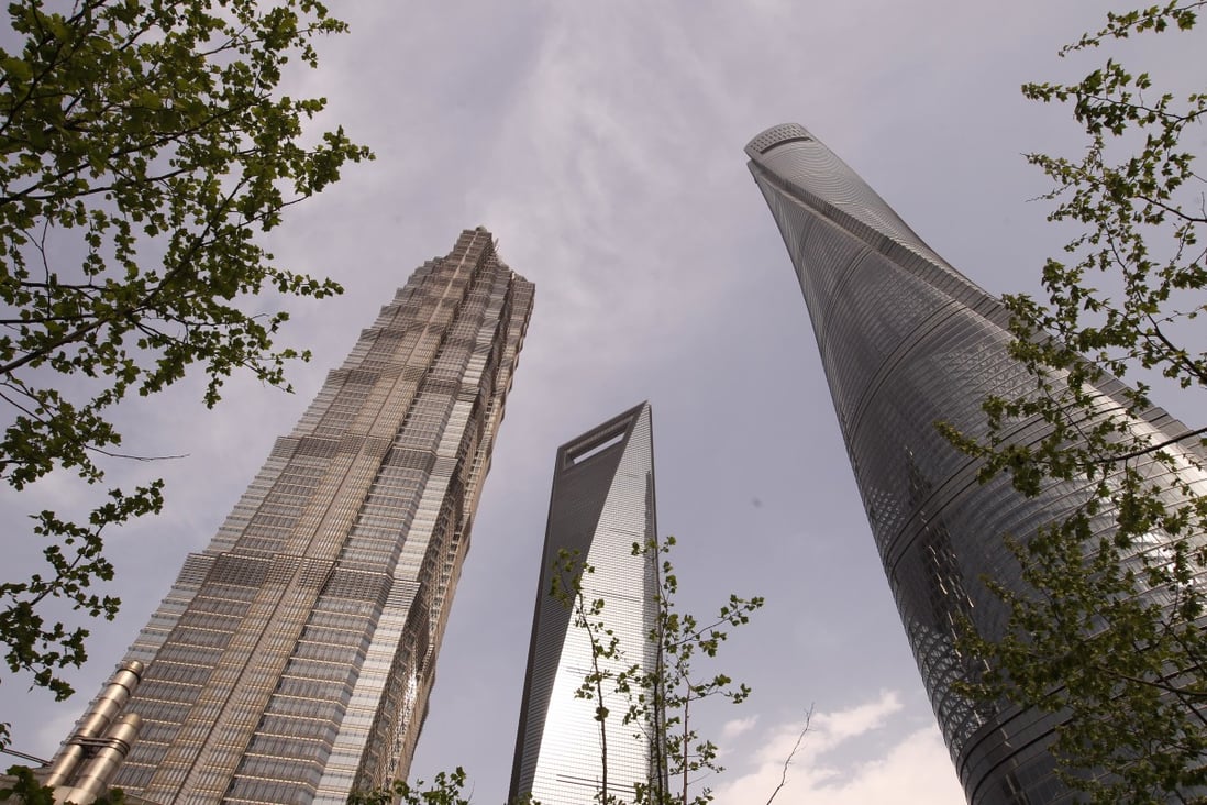 Grade A office space equalling about 12 times the total space in Shanghai Tower, right, and more than 18 times the total space in Shanghai World Financial Centre, middle, was lying empty in China’s four largest commercial hubs by the end of the first quarter. Photo: Simon Song