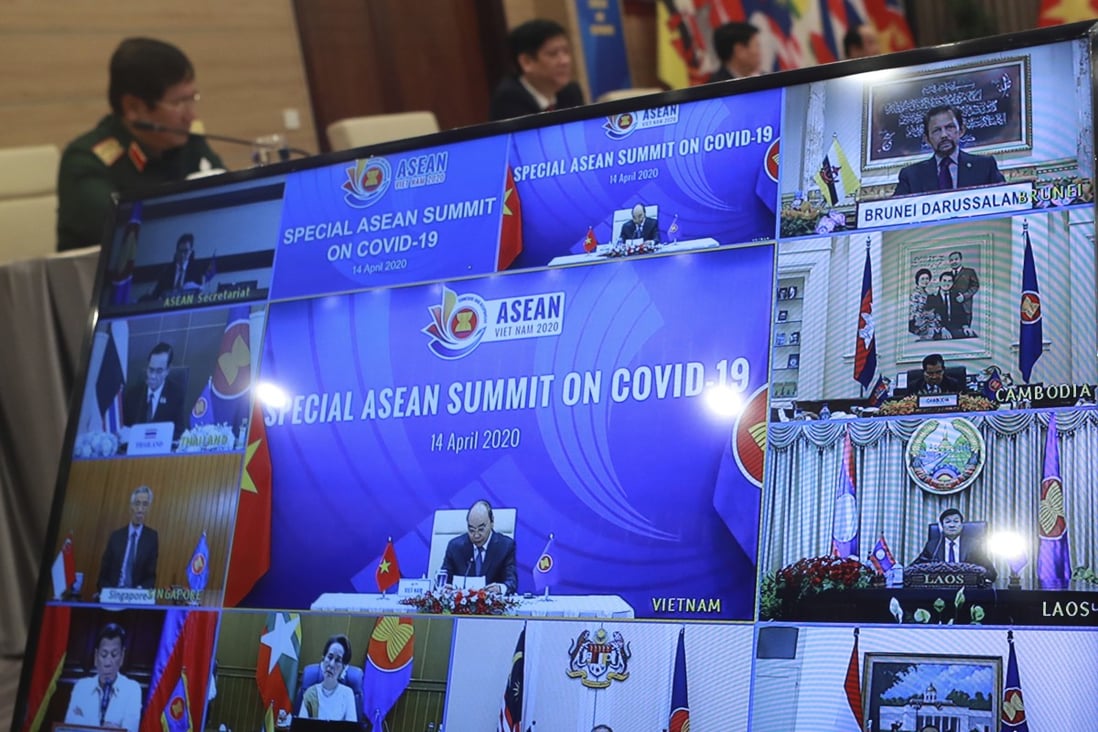 Vietnamese Prime Minister Nguyen Xuan Phuc (centre of TV screen) addresses delegates at a special Asean Summit on Covid-19 held online, as shown on a TV screen in Hanoi, Vietnam. Photo: AP