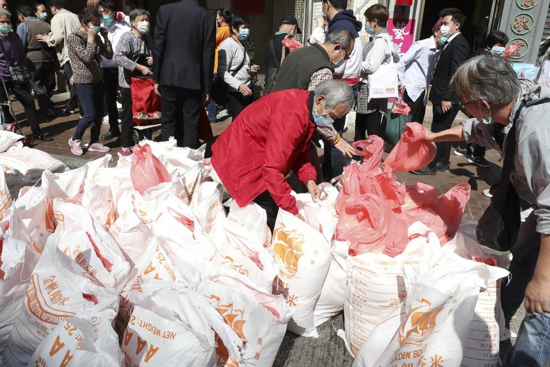 People queuing up for rice distributed by a shop in Sham Shui Po in February. Photo: Nora Tam