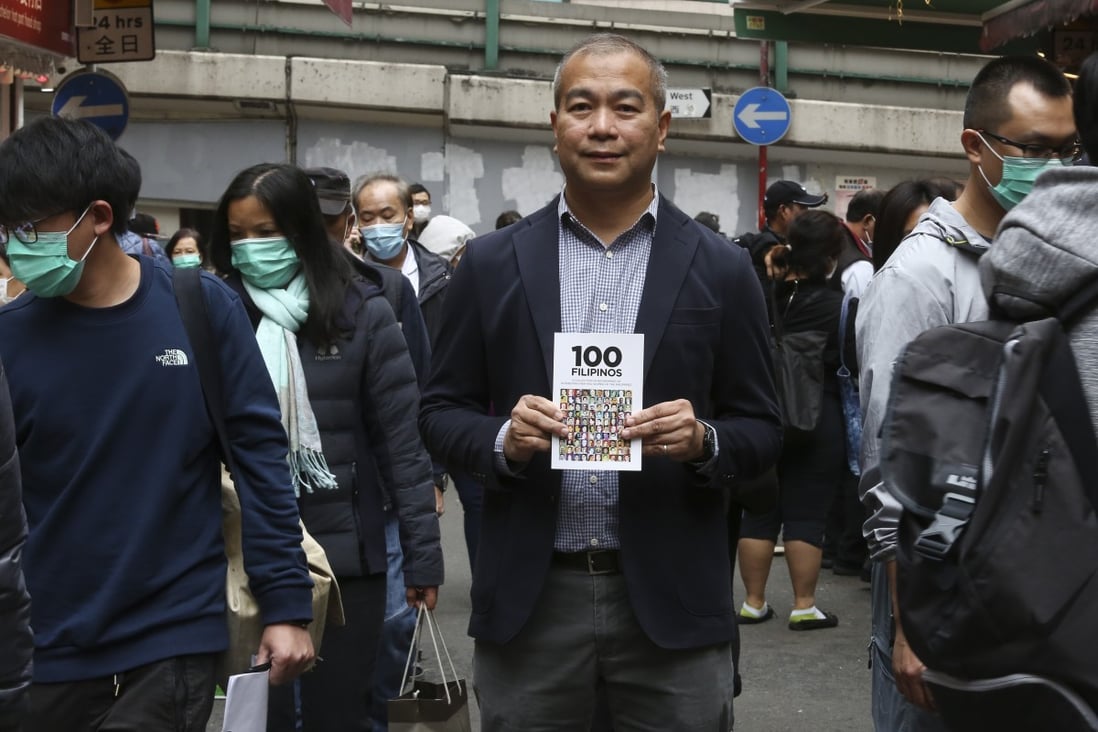 Noel de Guzman with his book 100 Filipinos in Causeway Bay, Hong Kong. In it, De Guzman lists 100 outstanding men and women who have made significant contributions to the Philippines. Photo: Jonathan Wong