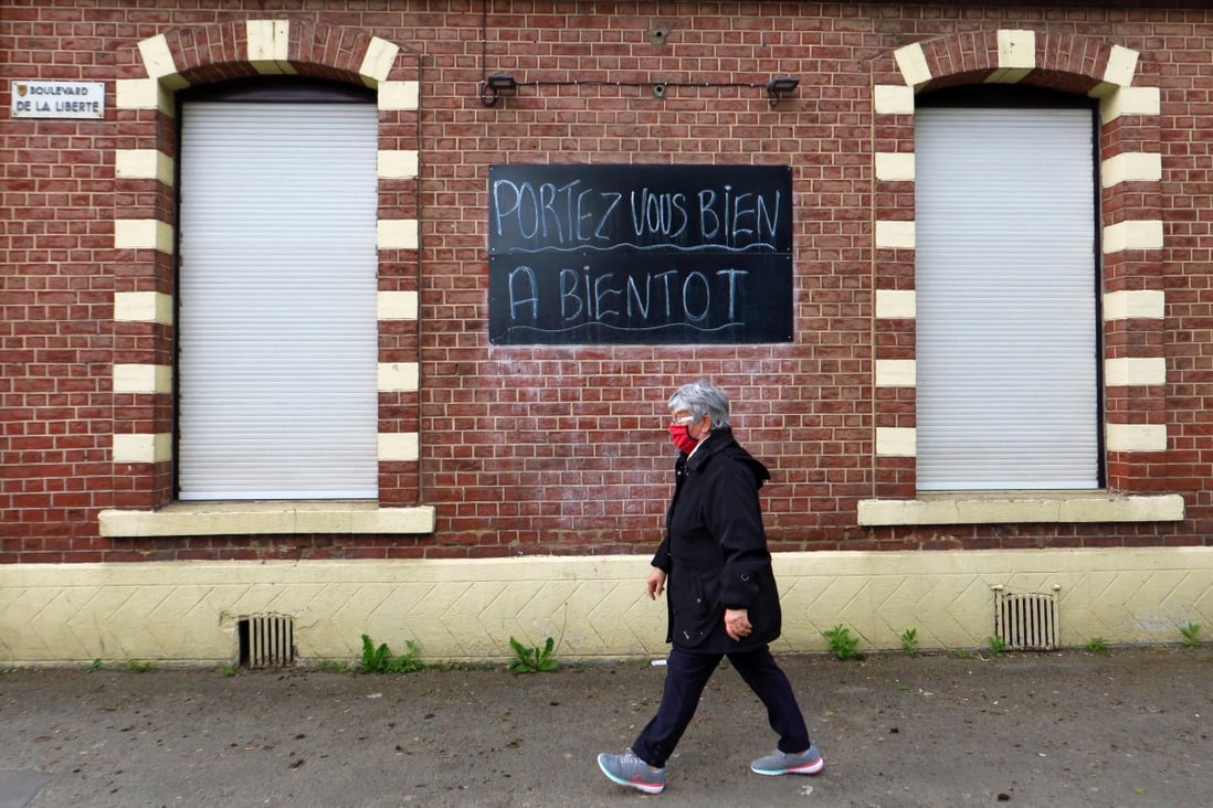 A woman walks past a closed bar on which reads ''take care, see you soon", during the lockdown imposed to slow down the spread of the coronavirus disease (COVID-19) in Cambrai, France, May 3, 2020. Photo: Reuters