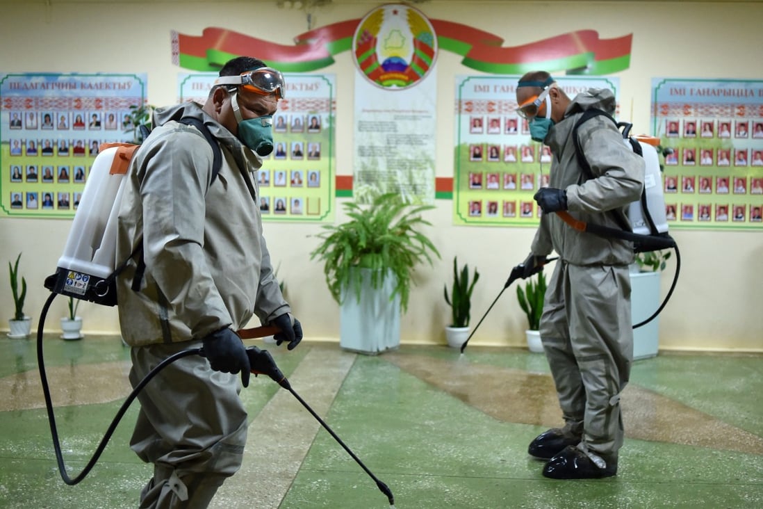 Belarus servicemen wearing protective gear disinfect a school outside Minsk. Photo: AFP