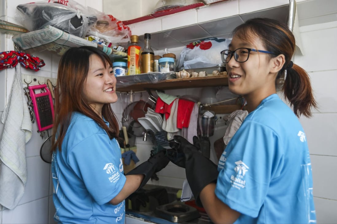 Two student volunteers from The Education University of Hong Kong, Rose Tsui (left) and Katherine Ho, help clean the home of an elderly lady in Kai Yip Estate in Kowloon Bay. Photo: Xiaomei Chen