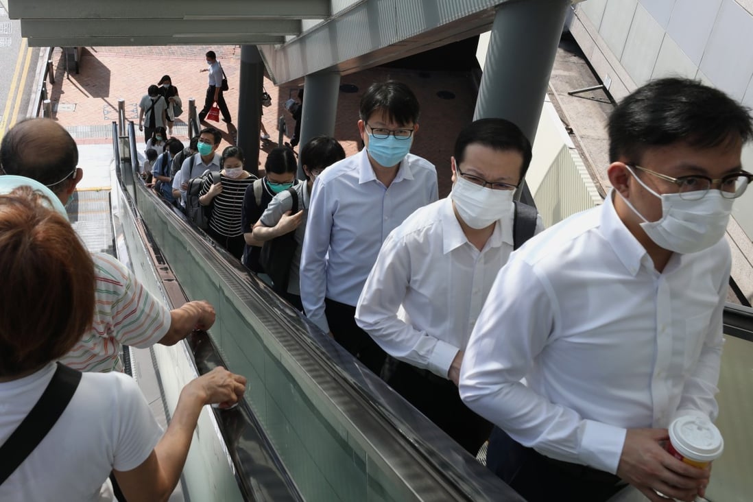 Civil servants go back to work at the government headquarters in Admiralty on May 4, as Hong Kong starts to relax Covid-19 measures. Photo: Nora Tam